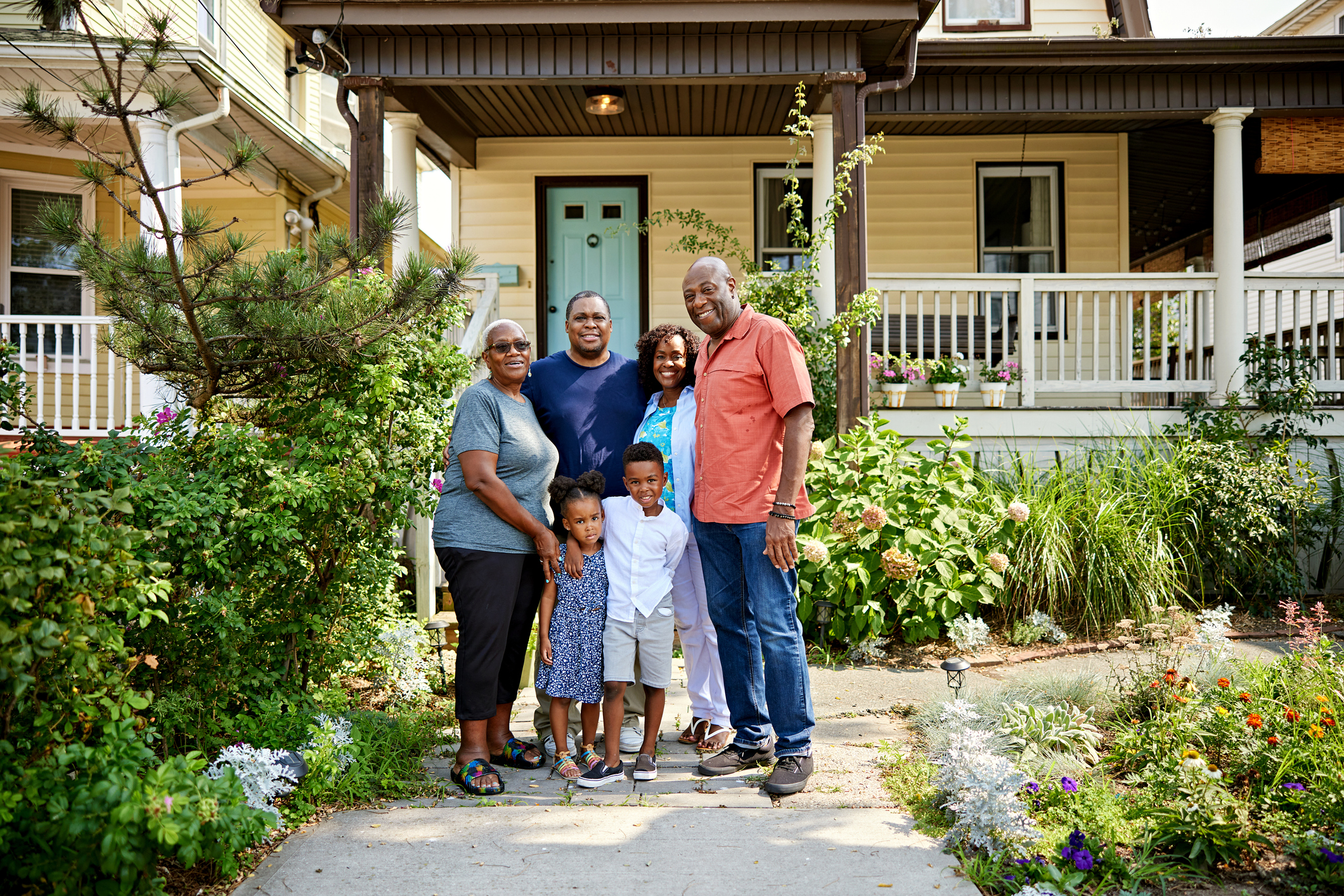 Multi-generational family standing together outside their home